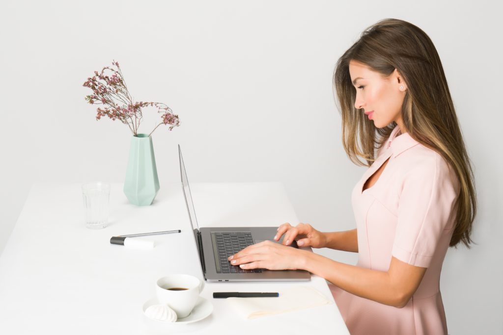 woman in pink dress using laptop computer 1586973 1 scaled